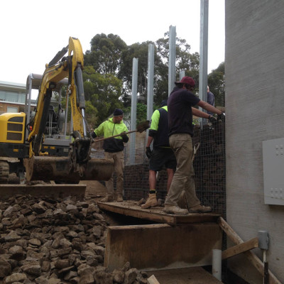 Adding rocks to gabion retaining wall